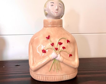 Decantador con forma de niña florecida en forma de corazón