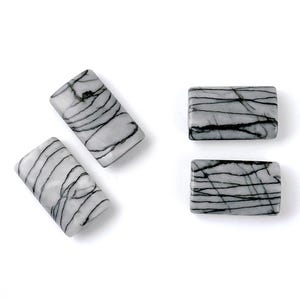 May include: Four rectangular black and white striped stones. The stones are smooth and polished.