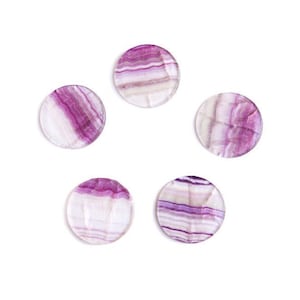 May include: Five round, purple and white striped fluorite coasters. The coasters are smooth and polished.