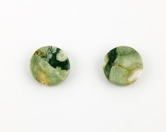 May include: A pair of round green, white, and brown jasper stone earrings. The stones have a mottled pattern.