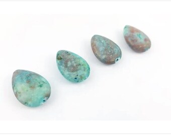 May include: Four teardrop-shaped beads with a hole drilled through the top. The beads have a mottled appearance with shades of teal, brown, and green. The beads are arranged diagonally on a white background.