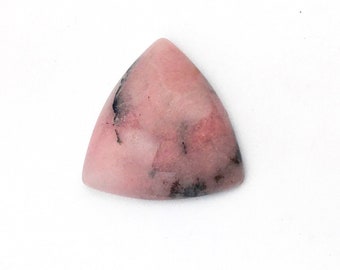 May include: A triangular pink and black gemstone cabochon with a smooth, polished surface.