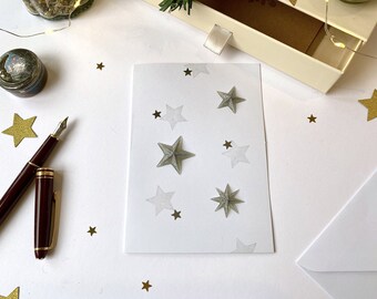Greeting card - festive stationery - golden or silver Christmas stars on a white background