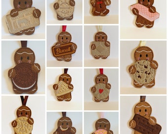 May include: Twelve gingerbread ornaments, each holding a different type of biscuit or cookie. The ornaments are brown and feature a smiling gingerbread person. The biscuits include:  "McVitie's Digestives", "Rich Tea", "Bourbon", "Ginger Nut", "Custard Cream", "Hobnobs", "Biscuit", "Chocolate Chip", "Oreo", "Pink Donut", "Pink Wafer", and a heart-shaped biscuit.