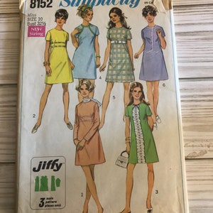 May include: Simplicity sewing pattern number 8152 for a dress. The pattern includes instructions for making five different styles of dresses. The pattern is for size 10, bust 32 1/2 inches. The pattern is labeled "Jiffy" and "easy cut, easy sew".