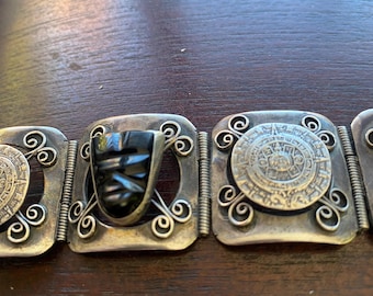 Vintage Mexican silver bracelet with obsidian masks and Aztec calendar