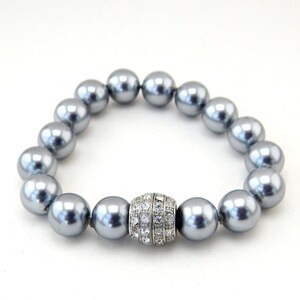 May include: A silver pearl bracelet with a silver and crystal clasp.