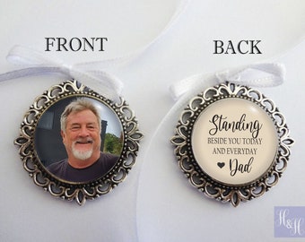 May include: A silver-toned memorial charm with a photo of a man on the front and the text "Standing beside you today and everyday Dad" on the back.