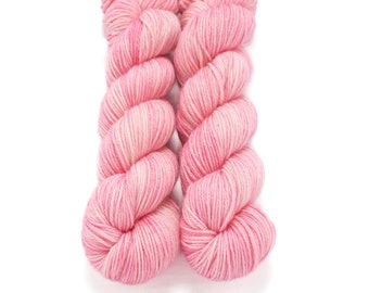 May include: Two skeins of pink and white yarn, twisted together.