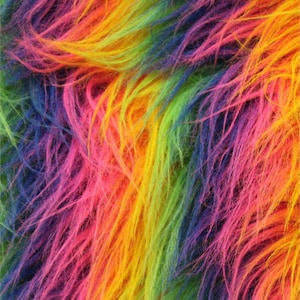 May include: Rainbow colored faux fur fabric with long, soft fibers. The fabric is a blend of pink, orange, yellow, green, blue, and purple.