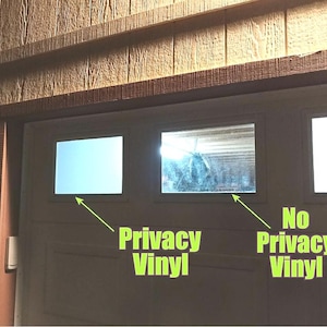 May include: A section of a garage door with three windows. The left window has privacy vinyl, appearing opaque, while the middle window, without privacy vinyl, is transparent. Text reads "Privacy Vinyl" and "No Privacy Vinyl".