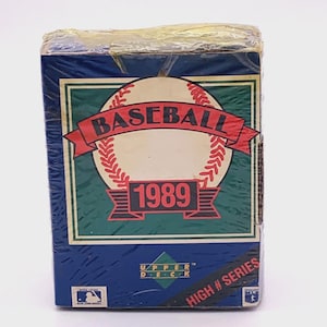 May include: A set of three ceramic mugs with a speckled, matte finish. The mugs are in shades of cream, light gray, and dark gray. Each mug has a simple, minimalist design and a rounded handle.