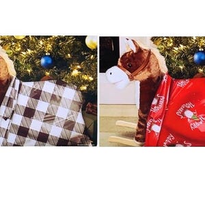 May include: A plush rocking horse with a brown and white checkered blanket draped over it. The horse has a brown mane and a white muzzle. A Christmas tree with ornaments is in the background.