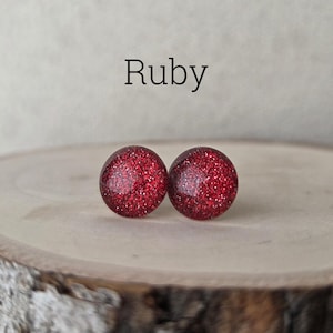 May include: A set of three ceramic mugs with a speckled, matte finish. The mugs are in shades of cream, light gray, and dark gray. Each mug has a simple, minimalist design, perfect for coffee or tea.