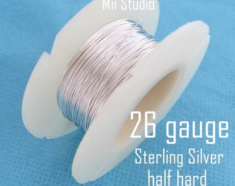 May include: A spool of 26 gauge sterling silver wire, half hard. The wire is wound around a white plastic spool.