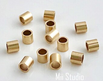 May include: A group of 12 gold-colored metal jump rings. The jump rings are round and have a smooth finish.