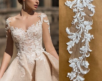 May include: White lace trim with a floral design on a sheer mesh background. The lace is delicate and intricate, with a variety of floral motifs. This trim is perfect for adding a touch of elegance to any project.