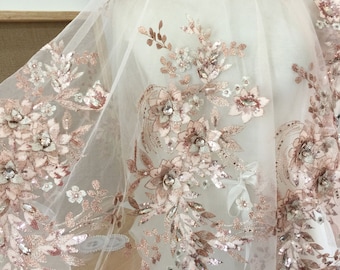 May include: Rose gold floral lace fabric with sequins and beads. The lace is on a sheer tulle background.