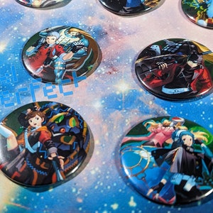 May include: Ten round, colourful buttons featuring anime characters. The buttons are printed with images of characters from a popular anime series.