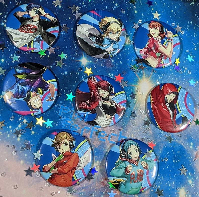 May include: Set of 8 colourful round pins featuring anime characters with headphones. The pins are decorated with a variety of designs, including geometric patterns, stars and musical notes.