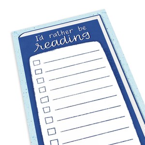 May include: A blue and white bookmark with the text "I'd rather be reading" at the top. The bookmark has a list of checkboxes, perfect for tracking reading progress. The design is simple and clean, ideal for book lovers.