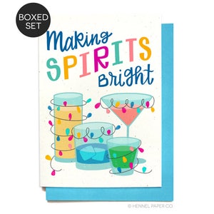 May include: A greeting card with a festive design featuring colorful cocktails with string lights wrapped around them. The text on the card reads "Making Spirits Bright".