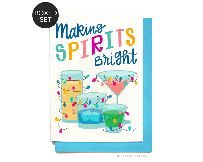 May include: A greeting card with a festive design featuring colorful cocktails with string lights wrapped around them. The text on the card reads "Making Spirits Bright".