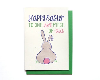 May include: A light green card with a cartoon bunny rabbit with a pink tail. The card says "Happy Easter to one hot piece of tail".