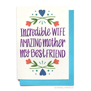May include: Greeting card with a white background and a blue border. The card features the text "Incredible WIFE AMAZING mother my Best FRIEND" in purple, with floral and heart illustrations in red, green, and blue.