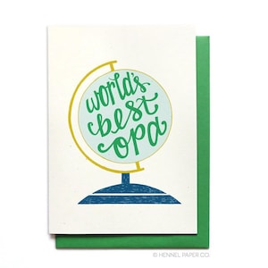 May include: A greeting card with a green globe illustration and the text "World's Best Opa".