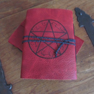 Devil&#39;s Trap. 2 red leather wrap notebooks/journals