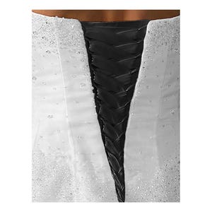 May include: White wedding dress with a black satin corset back. The corset has a lace-up design.