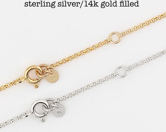 May include: Two extender chains, one in 14k gold filled and one in sterling silver, featuring round spring ring clasps and small circular tags. The text "Extender Chain" and "sterling silver/14k gold filled" is printed above the chains.