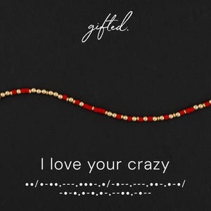 May include: A beaded bracelet featuring alternating red cylindrical beads and small metallic gold spherical beads. The text "gifted." appears at the top, and the phrase "I love your crazy" is written below with Morse code dots and dashes.