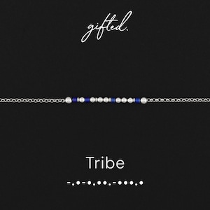 May include: A silver chain bracelet featuring a central segment of alternating small silver beads and dark blue cylindrical beads arranged in a Morse code pattern. The text gifted. appears above the bracelet, with Tribe and Morse code below.