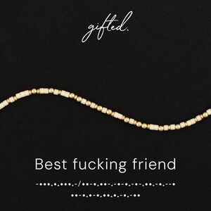 May include: A beaded necklace with a mix of white and gold beads, set against a black background. The word "gifted" is written in cursive at the top, and the phrase "Best fucking friend" is displayed below the necklace.