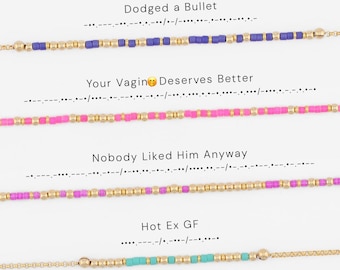 May include: Four beaded bracelets featuring Morse code patterns. The first is purple and gold with the text Dodged a Bullet. The second is pink and gold with the text Your Vagin Deserves Better. The third is pink and gold with the text Nobody Liked Him Anyway. The fourth is turquoise and gold with the text Hot Ex GF.