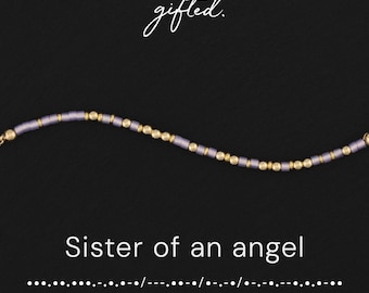 May include: A beaded bracelet featuring alternating lavender cylindrical beads and gold-toned spherical beads. The text "gifted." appears at the top, with "Sister of an angel" and a Morse code sequence printed below the jewelry.