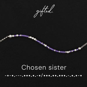 May include: A silver necklace with a purple and silver beaded design. The words "gifted" and "Chosen sister" are displayed on a black background. Morse code is also included below the text.