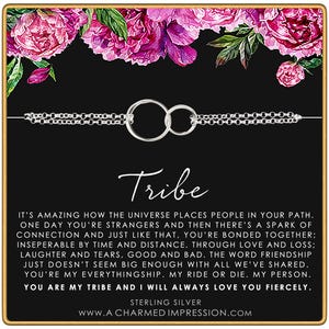 May include: A sterling silver necklace with two interlocking circles, presented on a black card with the word "Tribe" in script. The card is decorated with pink floral accents and includes a message about friendship.