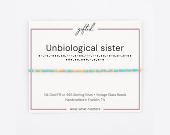 May include: A beaded bracelet featuring alternating turquoise and gold-colored beads on a white display card. The card displays the text "gifted.", "Unbiological sister", Morse code, and "14k Gold Fill or .925 Sterling Silver • Vintage Glass Beads".