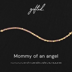May include: A beaded bracelet featuring alternating metallic gold spheres and cylindrical mauve beads. The text gifted. appears above the bracelet, while the text Mommy of an angel and a corresponding Morse code sequence are printed below it.