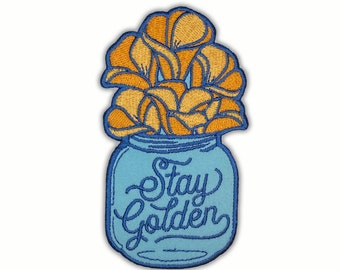 May include: An embroidered patch with a blue mason jar filled with yellow flowers. The jar has the text "Stay Golden" in blue cursive writing.