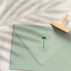 May include: A green envelope with a custom return address stamp featuring a palm tree, the text "Shelby & David Cassidy", and the address "232 Sunset Way, Miami, Florida 12345".