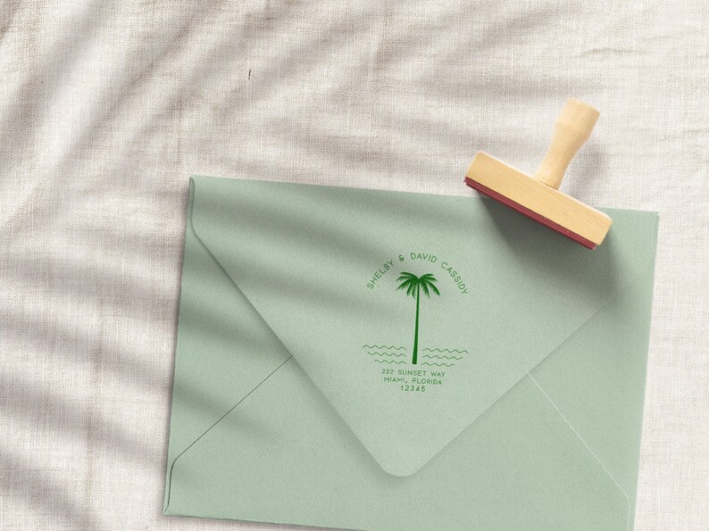 May include: A green envelope with a custom return address stamp featuring a palm tree, the text "Shelby & David Cassidy", and the address "232 Sunset Way, Miami, Florida 12345".