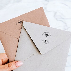 May include: Two brown envelopes with a palm tree and wave design stamp. The stamp reads "Shelby & David Casey" and includes their address.