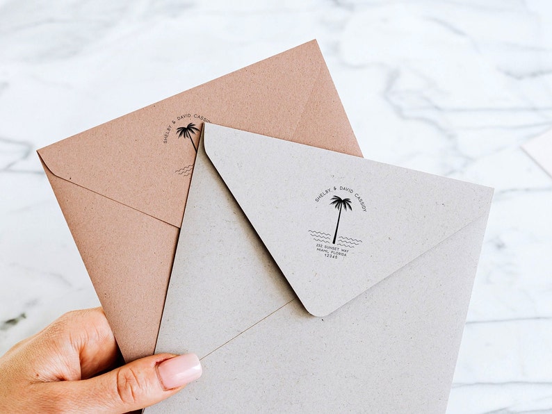 May include: Two brown envelopes with a palm tree and wave design stamp. The stamp reads "Shelby & David Casey" and includes their address.