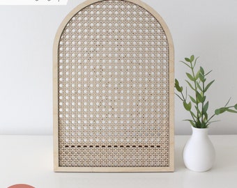 May include: A laser-cut wooden arch with a cane-like pattern. The arch is light brown and has a rounded top. The arch is standing on a white surface. "LASER tested" is written in black text on a white background in the top left corner of the image. "SVG LASER FILE | COMMERCIAL USE" is written in black text on a pink background at the bottom of the image.