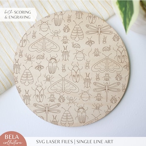 May include: A round wooden coaster with a laser-cut design of various insects, including butterflies, dragonflies, and beetles. The design is in a single line style and is repeated across the surface of the coaster. The text "both SCORING & ENGRAVING" is visible at the top of the coaster.