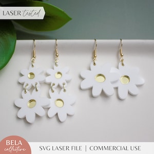 May include: White daisy earrings with gold centres. The earrings are laser cut and come in two styles: a single daisy and a double daisy.